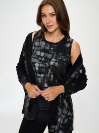 Woman modeling a Nylon Foil Sequin Contrast Jacket with a metallic foil front and black back panel.