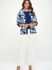 Model wearing Damboru Print Contrast Jacket with blue Magnolia print and mandarin collar, paired with white pants.