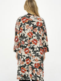 Woman wearing Hit Kimono Long Jacket With Pocket, showcasing floral design and relaxed fit from the back.