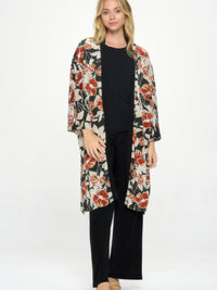 Hit Kimono Long Jacket With Pocket worn over a black outfit, featuring vibrant floral prints and side pockets.
