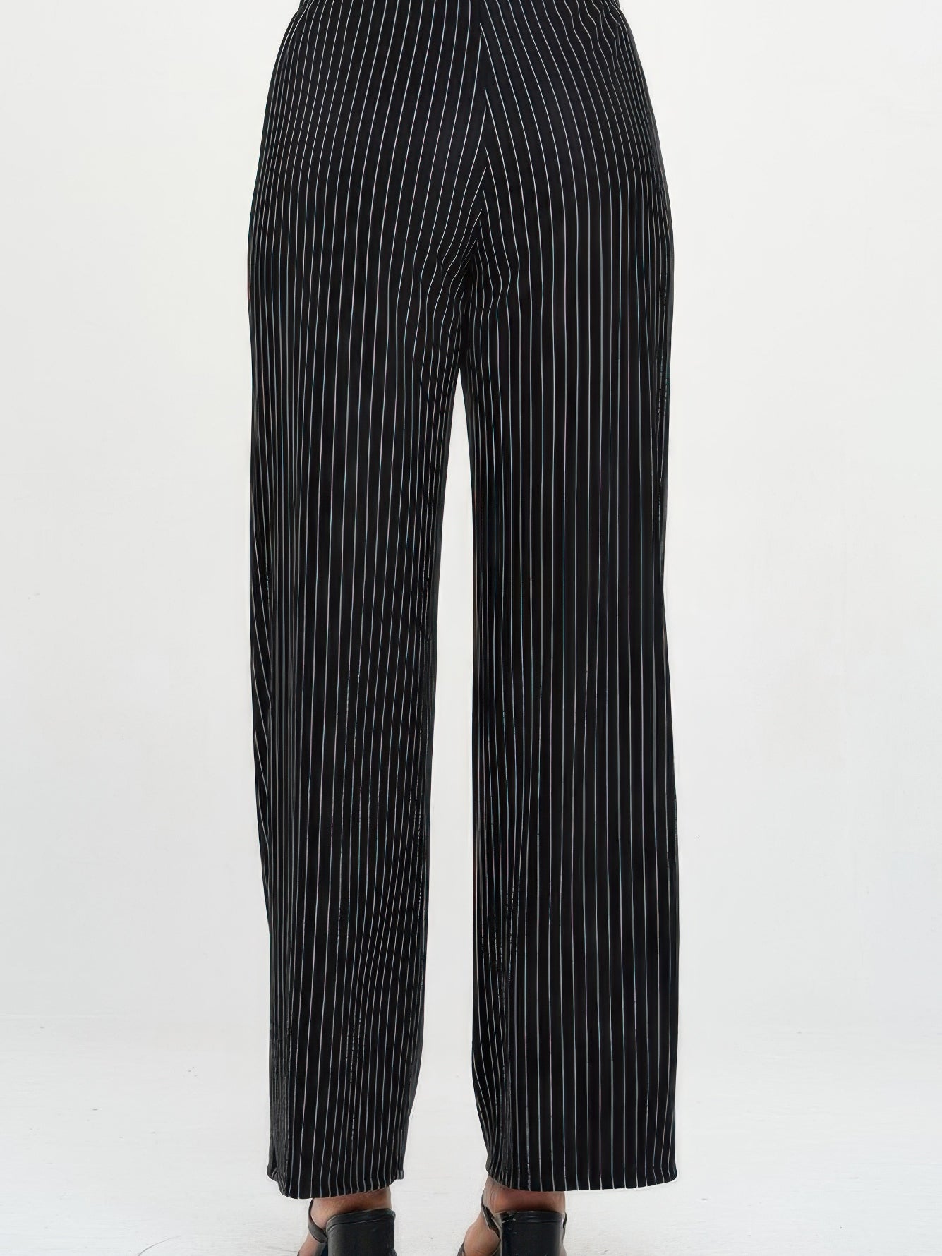 Ottoman Flared Pants in black with vertical stripes, showcasing the back view and relaxed fit.