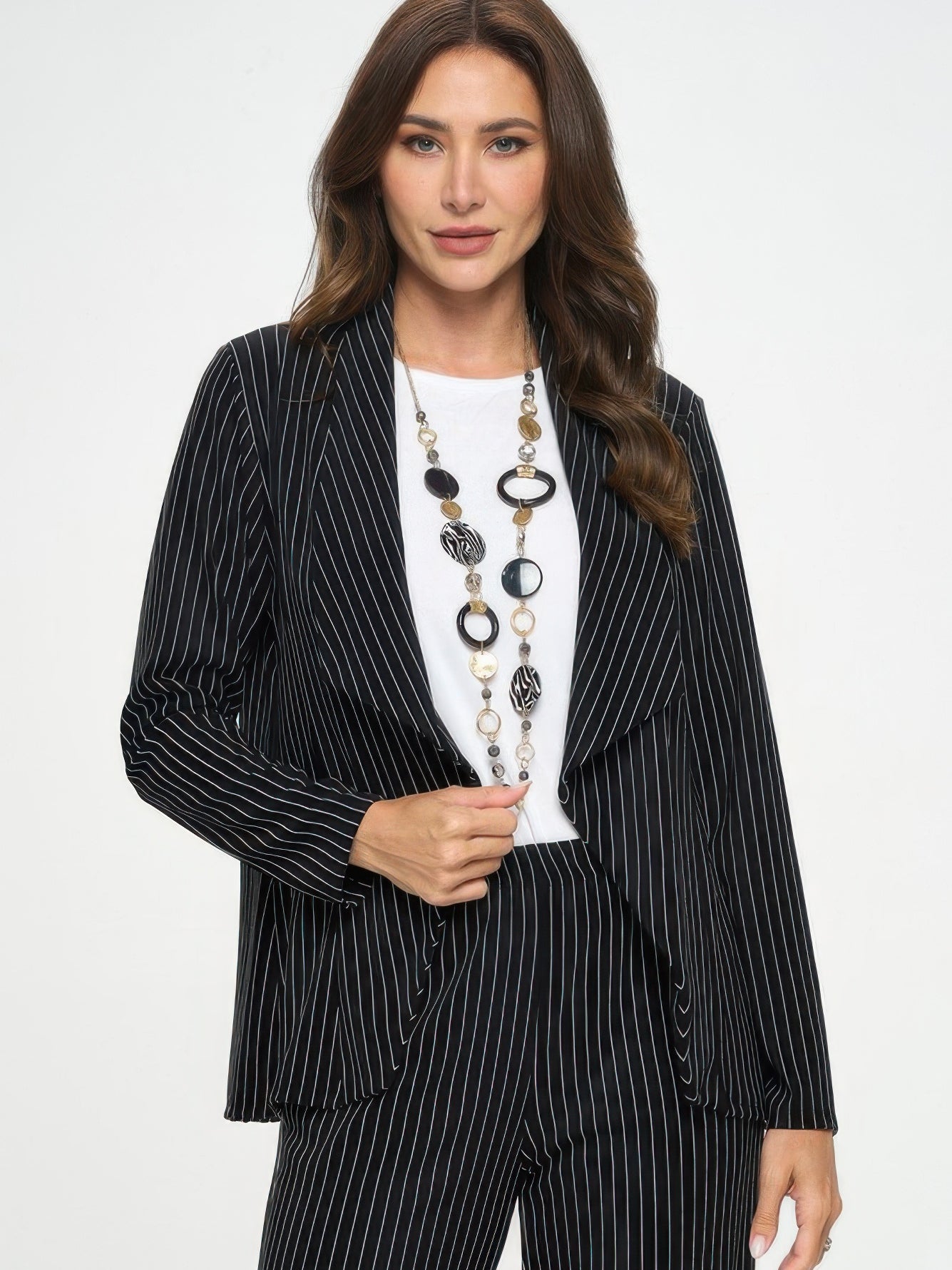 Ottoman Pinstripe Front Drape Jacket worn with a white top and statement necklace, showcasing a modern tailored look.