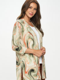 Model wearing a stylish Long Sleeve Cardigan with a bold printed finish in earthy tones.
