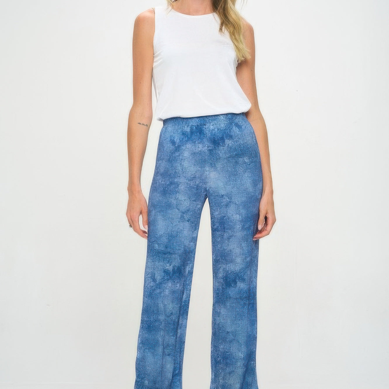 Model wearing Elastic Waistband Flared Pants with a white tank top, showcasing their comfortable fit and stylish denim print.