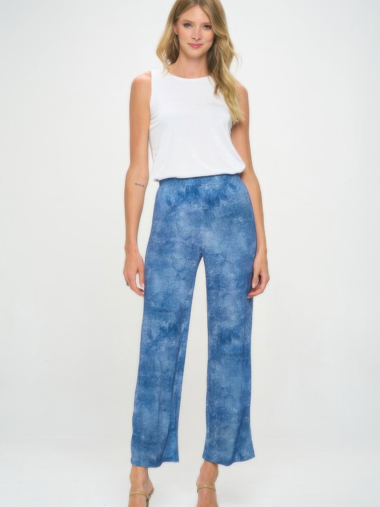 Model wearing Elastic Waistband Flared Pants with a white tank top, showcasing their comfortable fit and stylish denim print.