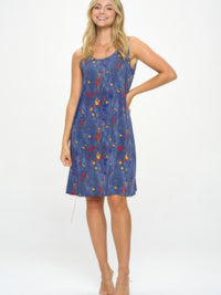 BNS Missy Tank Dress displayed by a model, featuring a sleeveless design and colorful print on a blue background.