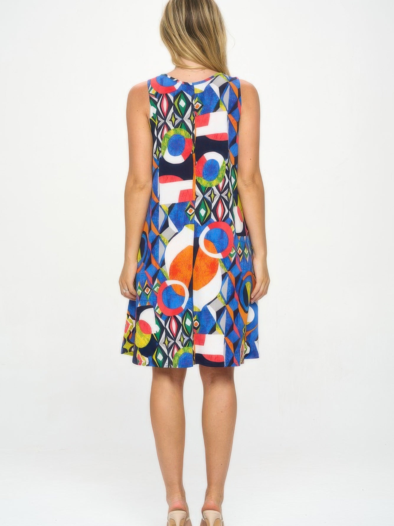 Model wearing HIT V-Neck Bias Pocket Tank Dress showcasing colorful print from the back.