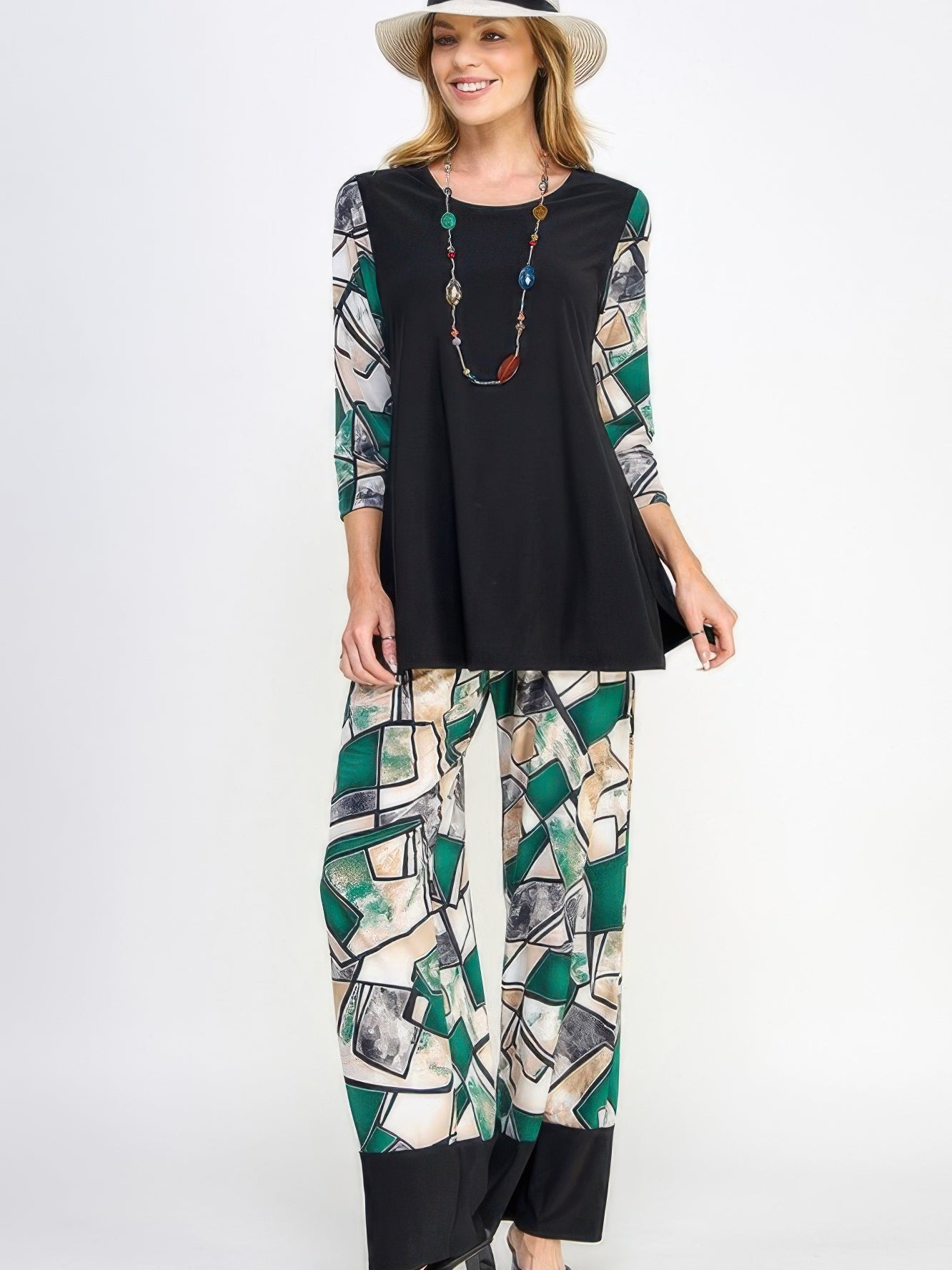 A model wearing HIT Flared Pants with a stylish black top and accessories, showcasing fluid movement and comfort.