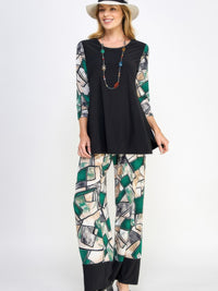 A model wearing HIT Flared Pants with a stylish black top and accessories, showcasing fluid movement and comfort.