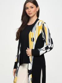 Contrast Jacket featuring a bold black-and-print design, highlighted by long sleeves and an open front, styled with a black top.