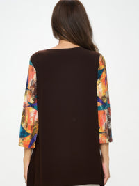 Back view of the Contrast Curve Knit Top showcasing colorful sleeves and a solid dark body.