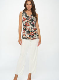 Crossover Tank in print featuring floral design and flattering V-neckline, paired with white pants.