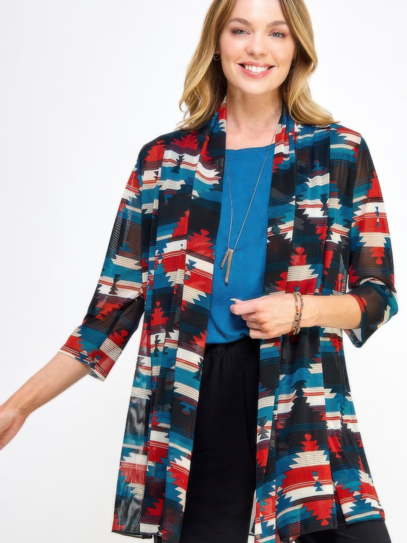 Woman wearing a colorful Mr Princess Jacket over a blue top and black pants, showcasing a stylish and versatile look.