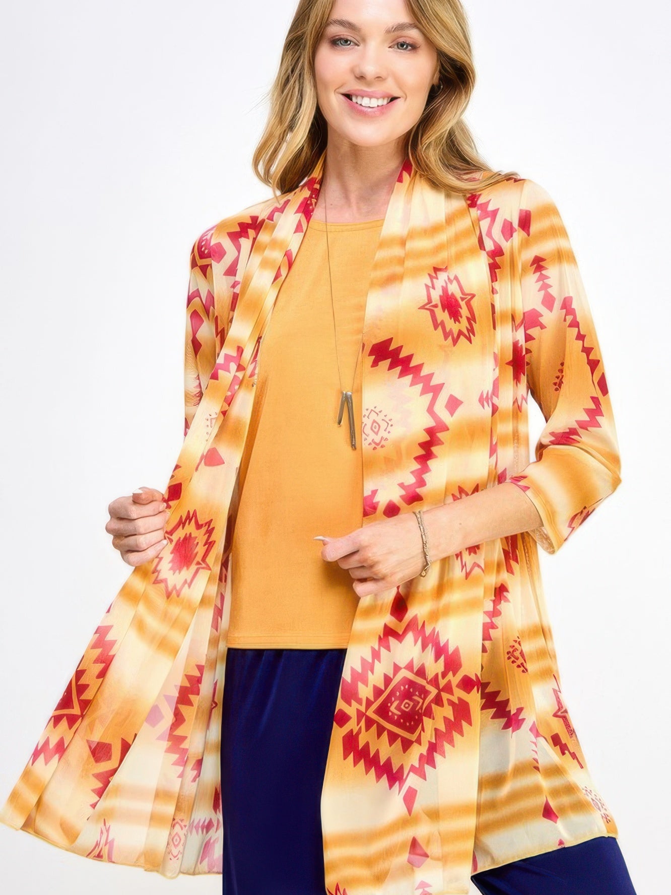 Model wearing a vibrant Mr Princess Jacket with orange and red patterns over a yellow top.