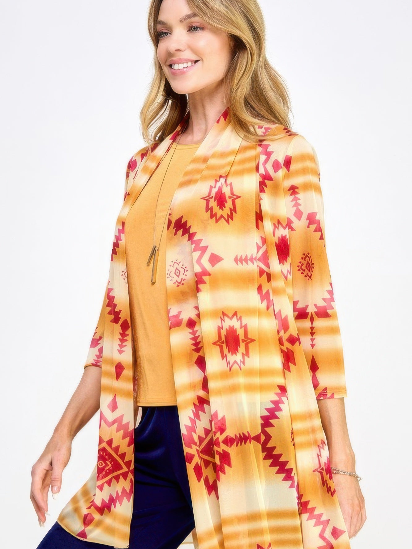 Woman models the Mr Princess Jacket with a colorful tribal pattern over a mustard top, showcasing its stylish versatility.