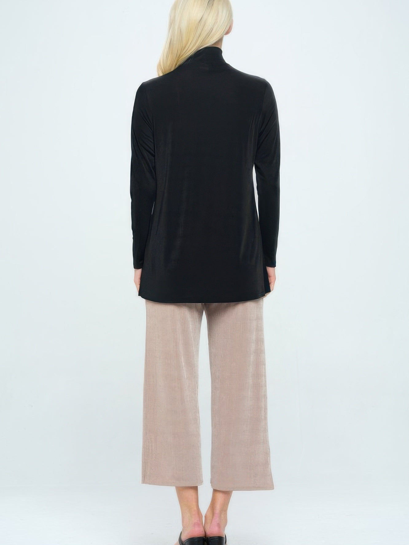 Model wearing BNS Mock Turtle Neck Top paired with light beige wide-leg pants from the back.