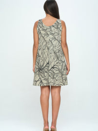 Back view of a woman wearing the Hit Missy Tank Dress featuring a leaf print design.