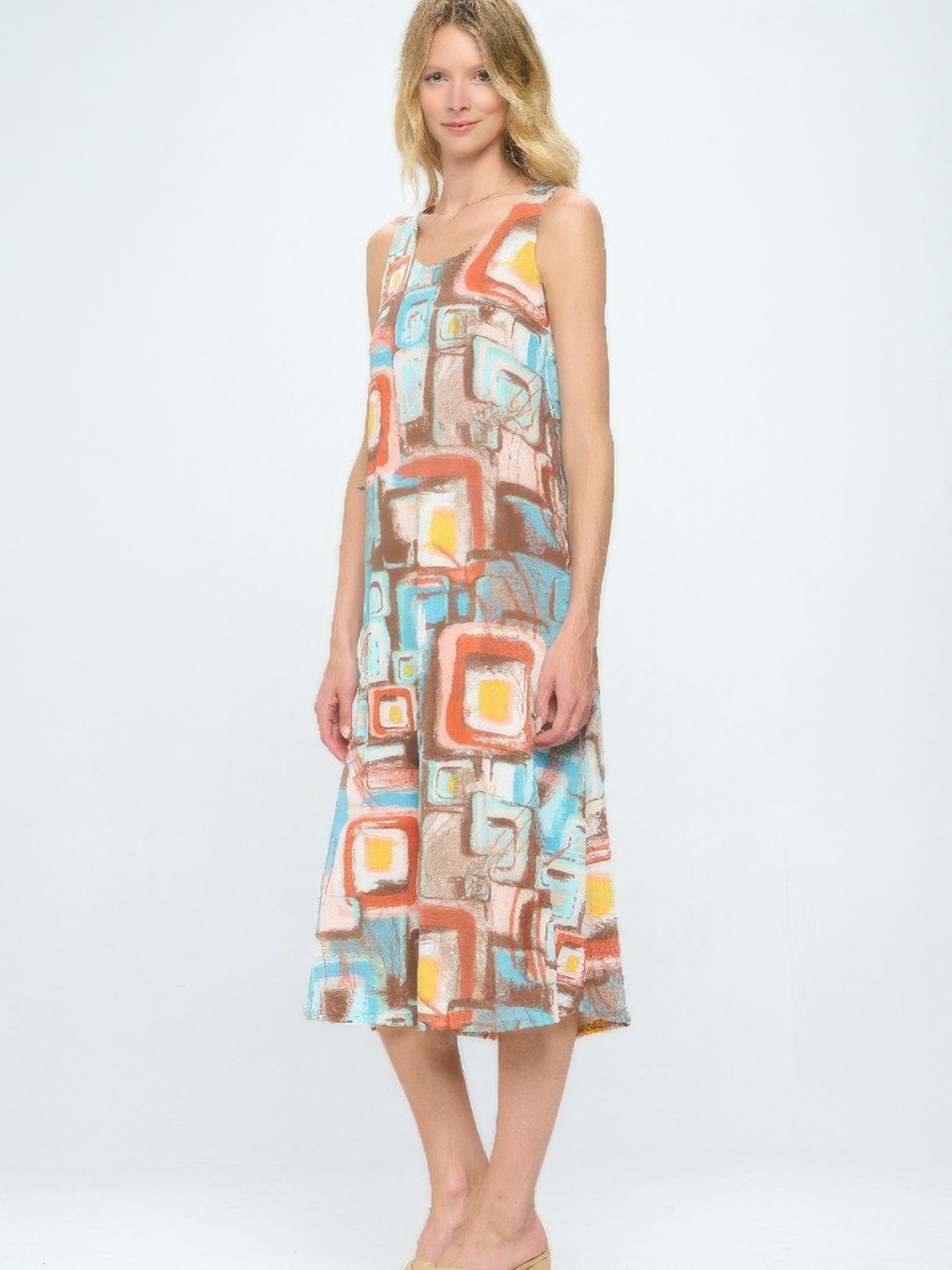Short Sleeve And Soft Round-Neckline Long Dress featuring colorful abstract print on a model standing.