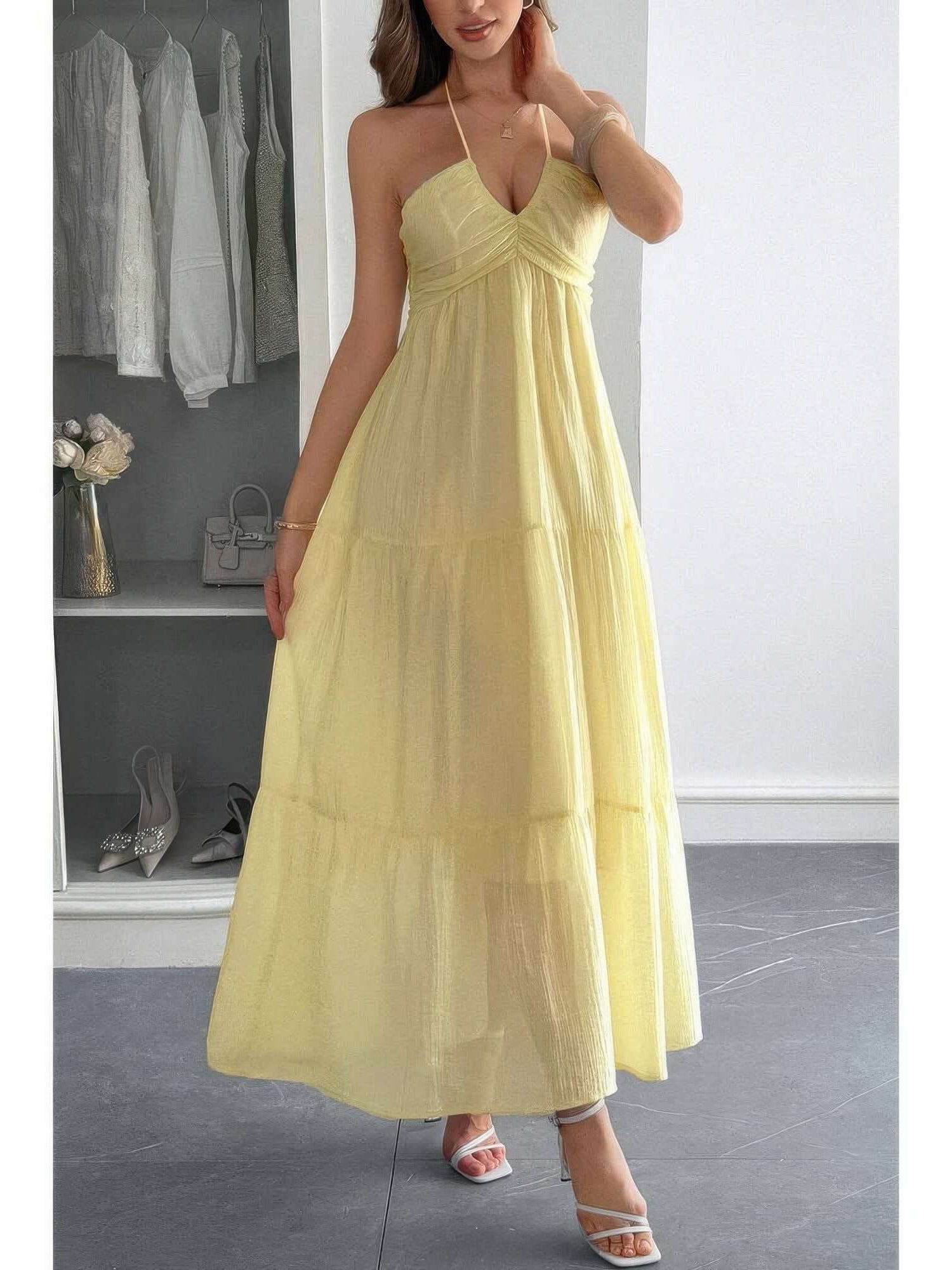 Solid Halter Muse Tiered Ruffle Long Dress in soft yellow with flowy layers and halter neckline, perfect for elegant occasions.