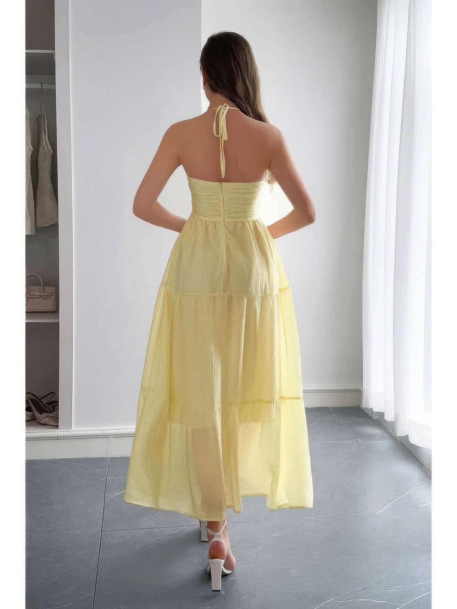 Solid Halter Muse Tiered Ruffle Long Dress in yellow with ruffled layers and halter neckline from the back.