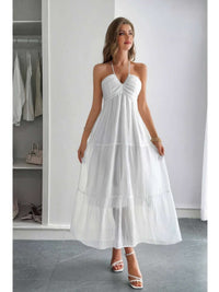 Solid Halter Muse Tiered Ruffle Long Dress worn by model in white, showcasing elegant ruffled layers and halter neckline.