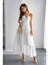 Model wearing a Solid Halter Muse Tiered Ruffle Long Dress in white, showcasing the flowy design and elegant ruffles.