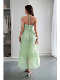 Back view of a model wearing the Solid Halter Muse Tiered Ruffle Long Dress in light green, showcasing the tiered ruffle design.