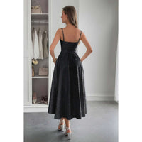 Back view of a model wearing a Solid Floral Jacquard Lace High Waist Dress in a stylish setting.