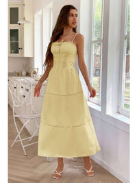 A model wearing a Solid Button Decor Pintuck Eyelet Shirred Dress in yellow, showcasing its feminine style and charm.