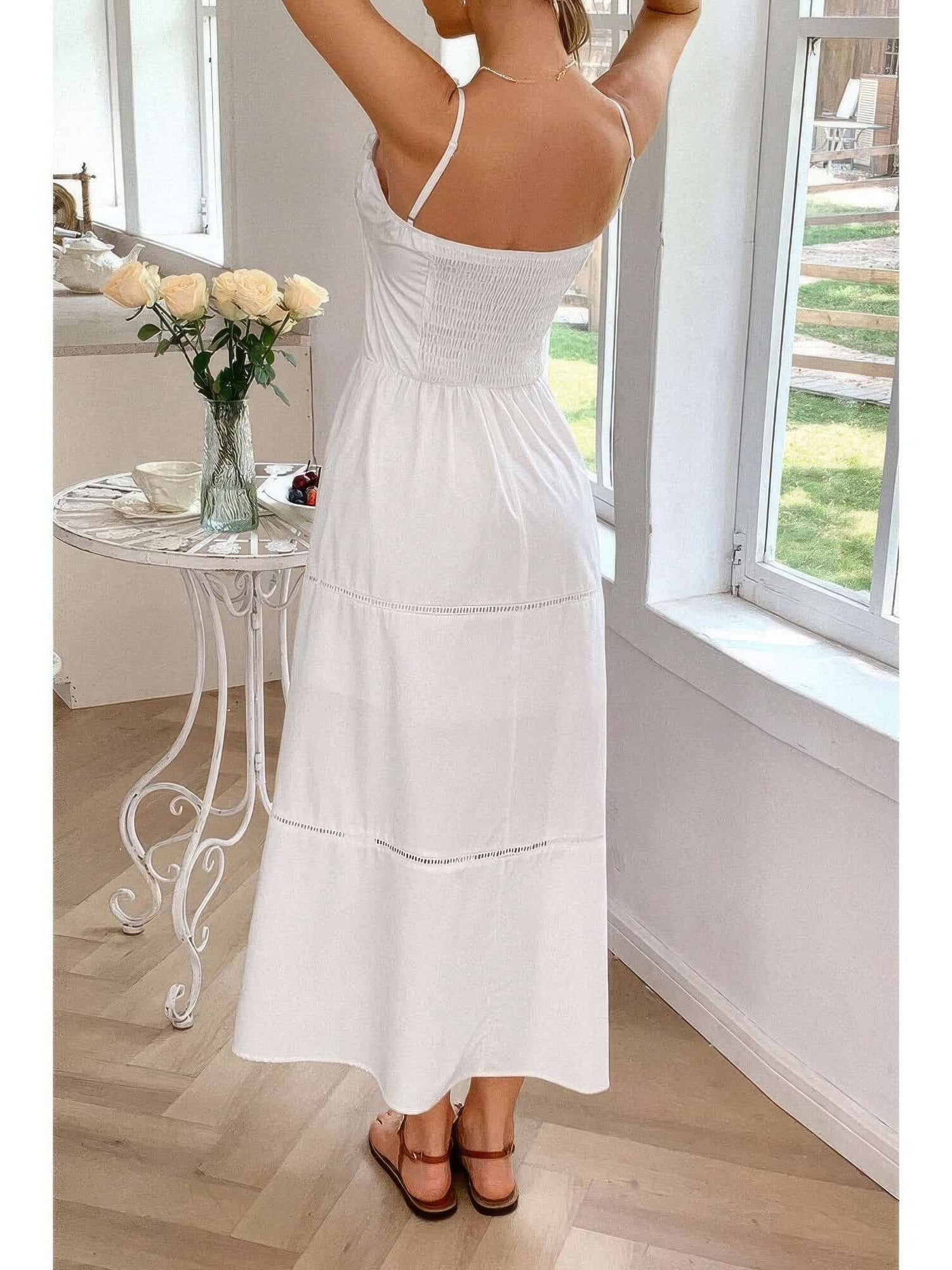 Rear view of a woman in a Solid Button Decor Pintuck Eyelet Shirred Dress, showcasing its feminine design and lightweight fabric.