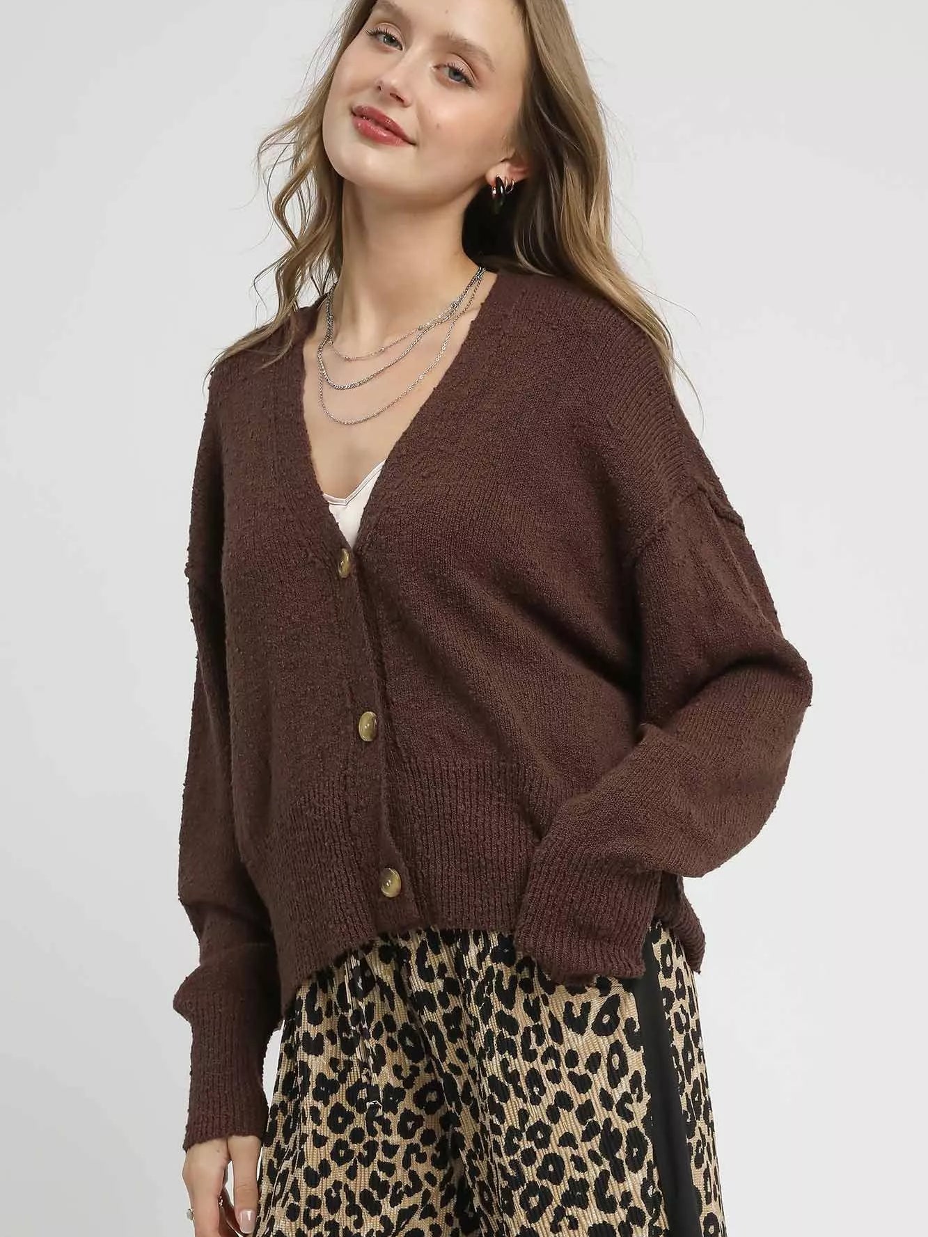 Umgee Button-Front V-Neck Knit Cardigan in brown worn with leopard print pants for a chic layered look.