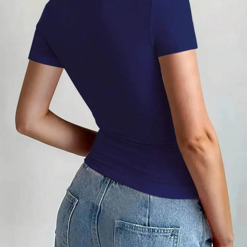 Back view of a woman wearing a Round Neck Short Sleeve T-Shirt in navy blue, paired with jeans.