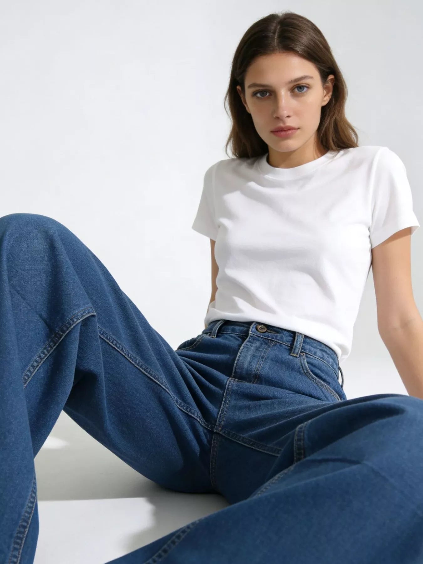 Model wearing Wide Leg Washed Jeans and a white t-shirt, showcasing relaxed fit and style.