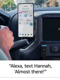 Person using Alexa in their car with smartphone displaying music controls and voice command feature.