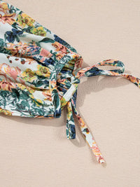 Close-up of the ruffled tie detail on the Floral Print Ruffle Hem Mini Dress.