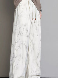 Men's Loose Fit Casual Pants featuring a drawstring design and pocketed style in a stylish marble print.