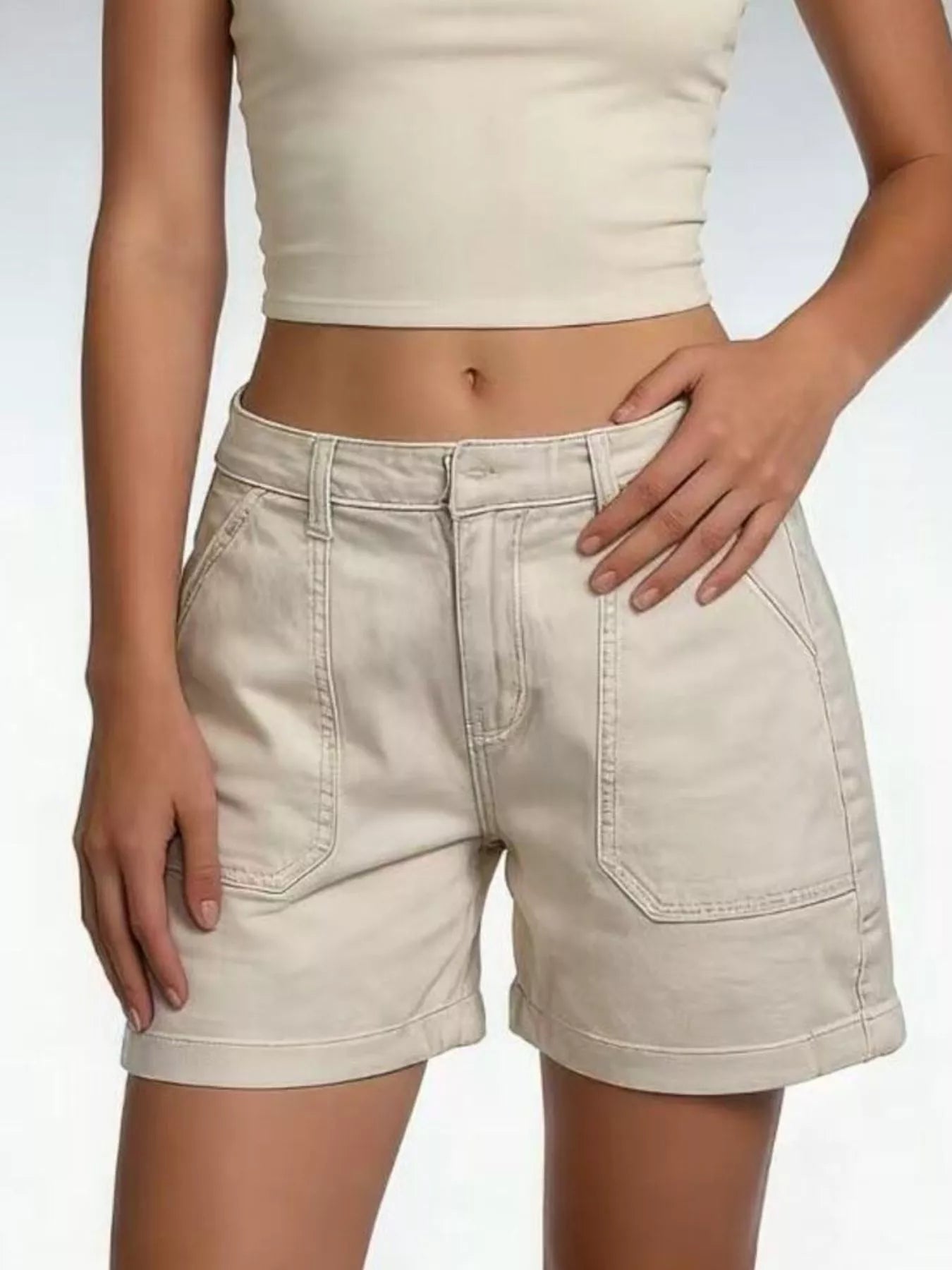 Pocketed Denim Shorts showcased in a casual style, featuring a classic buttoned design and pocket details.