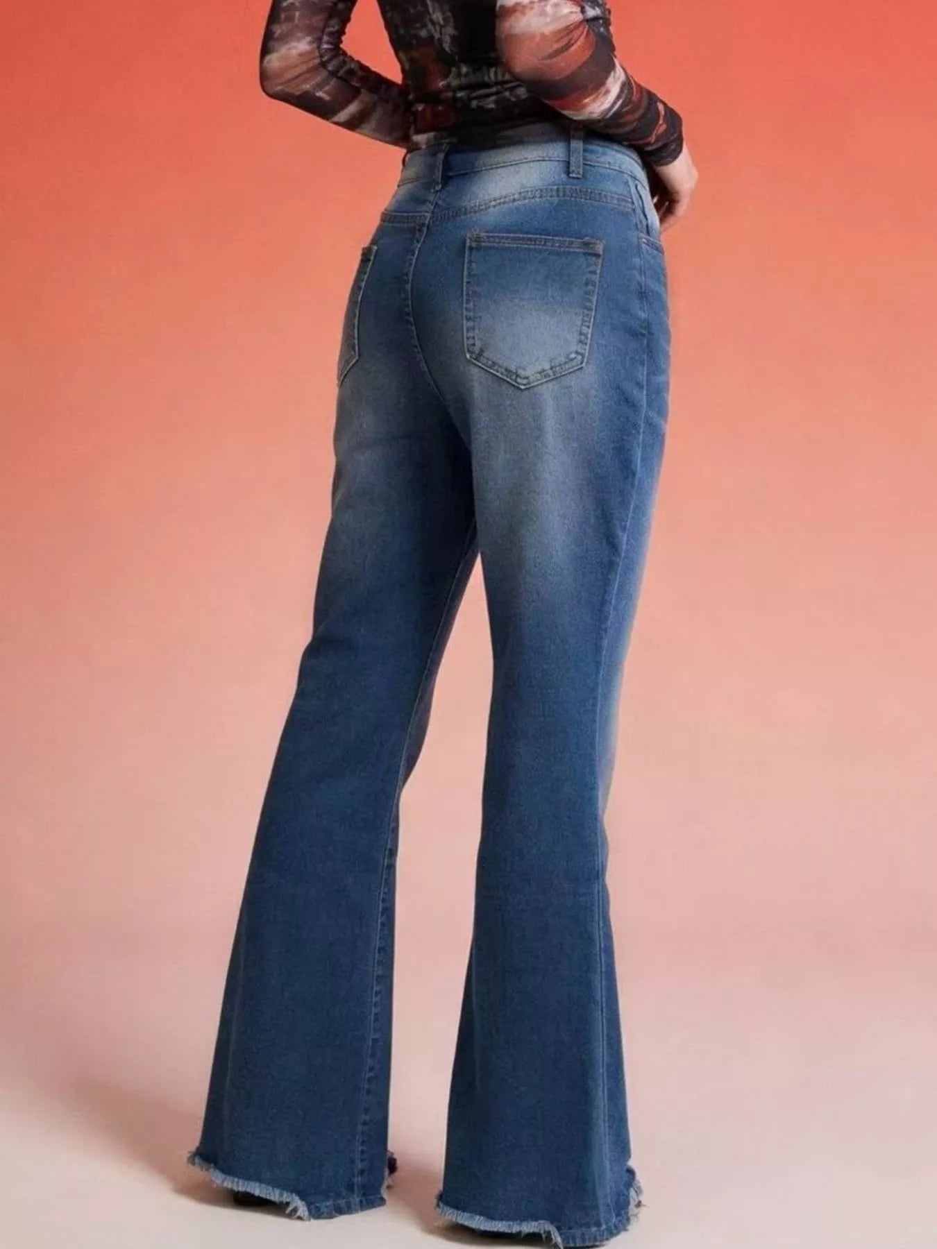 Back view of Raw Hem High-Waisted Flare Jeans showcasing the raw hem detail and pocketed design.