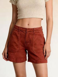 Pocketed Denim Shorts in rust color, featuring pockets and buttoned design, paired with a crop top.