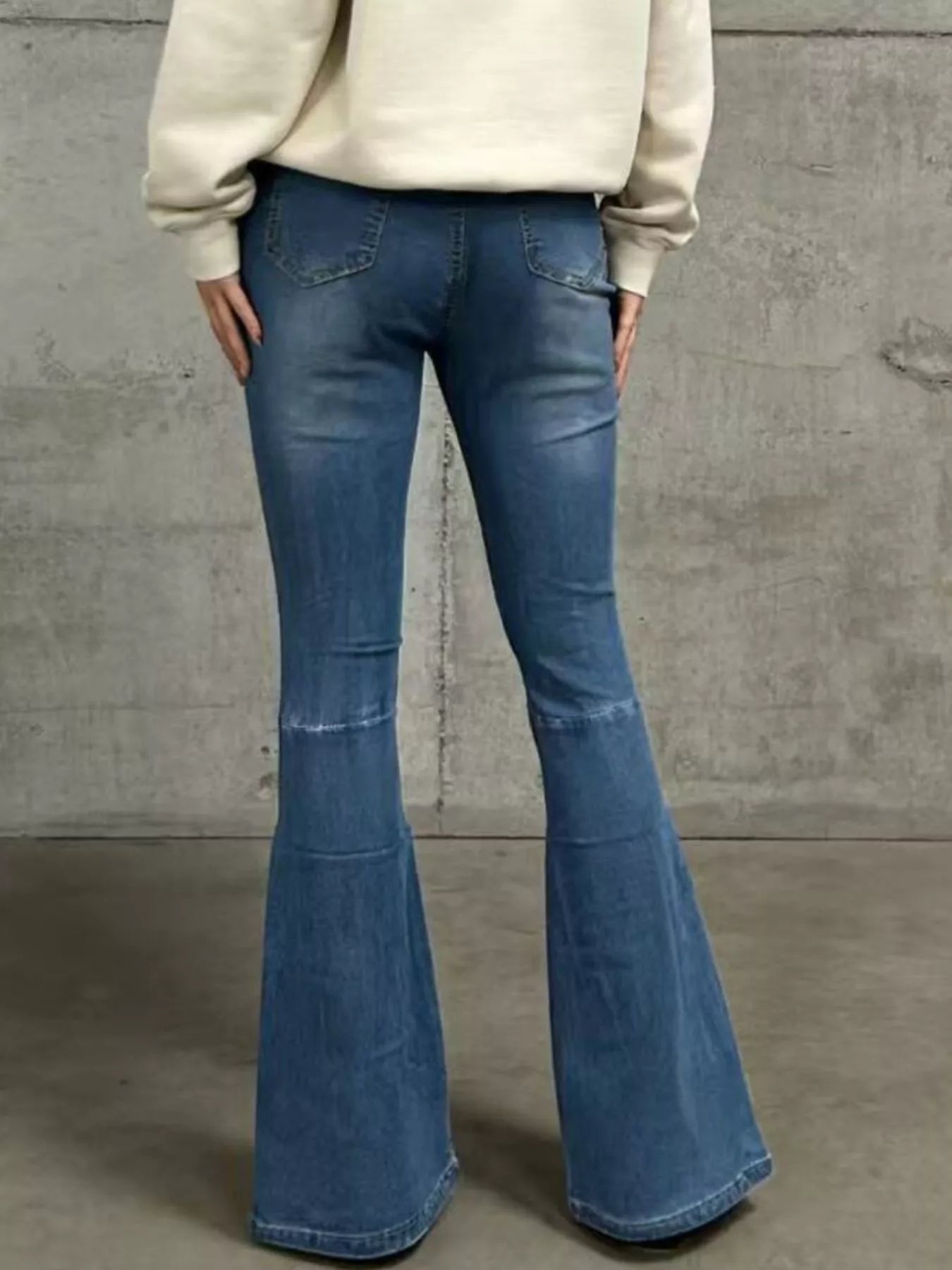 High-Waisted Flare Jeans in light blue denim, featuring a slightly stretchy material and flared hems.