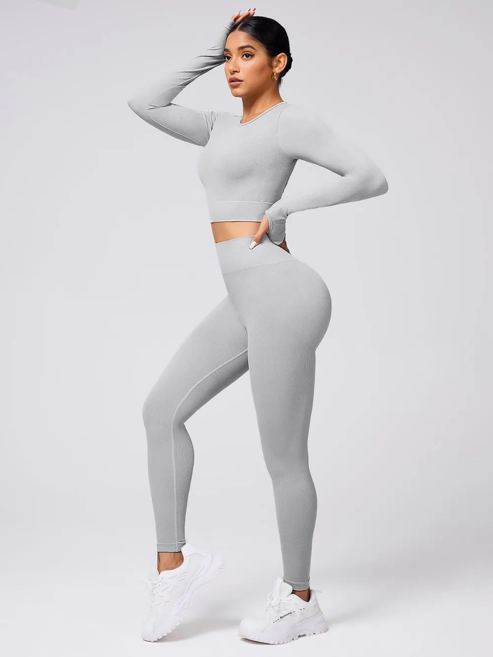 Back Crisscross Round Neck Long Sleeve Top and Leggings Active Set in grey worn by a model showcasing stylish workout wear.