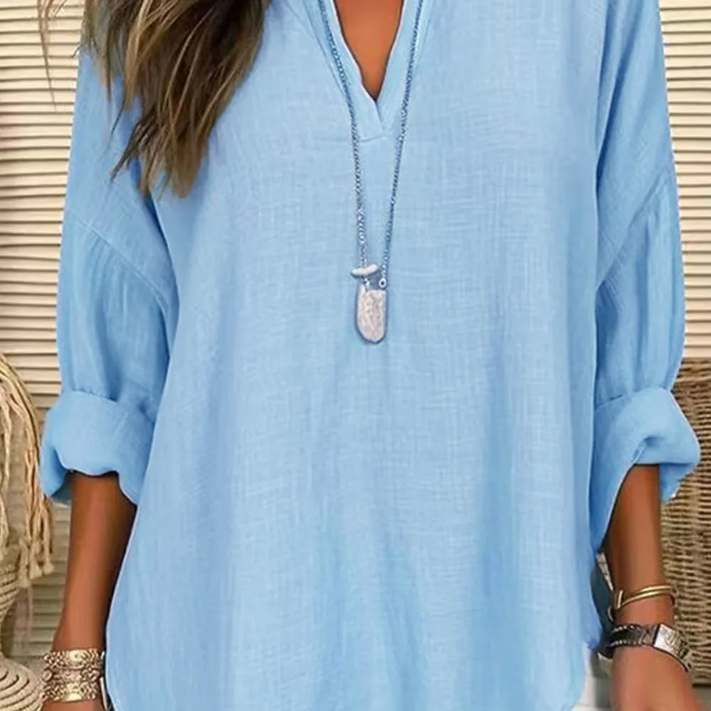 Solid Color Notched Long Sleeve Blouse in light blue, featuring a collar and rolled-up sleeves, styled with jewelry.