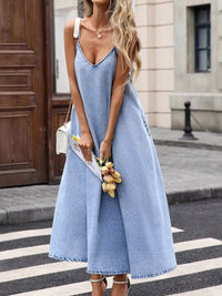 V-Neck Denim Cami Dress worn by a woman holding tulips, showcasing the relaxed fit and stylish denim design.