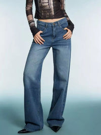 Model wearing Vintage Wash Wide Leg Jeans in a stylish pose with a modern background.