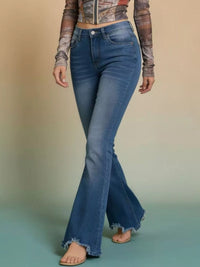 Model wearing Raw Hem High-Waisted Flare Jeans with a stylish top and sandals, showcasing the raw hem detail.