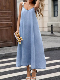V-Neck Denim Cami Dress worn by a model in blue denim, showcasing its relaxed fit and casual style.