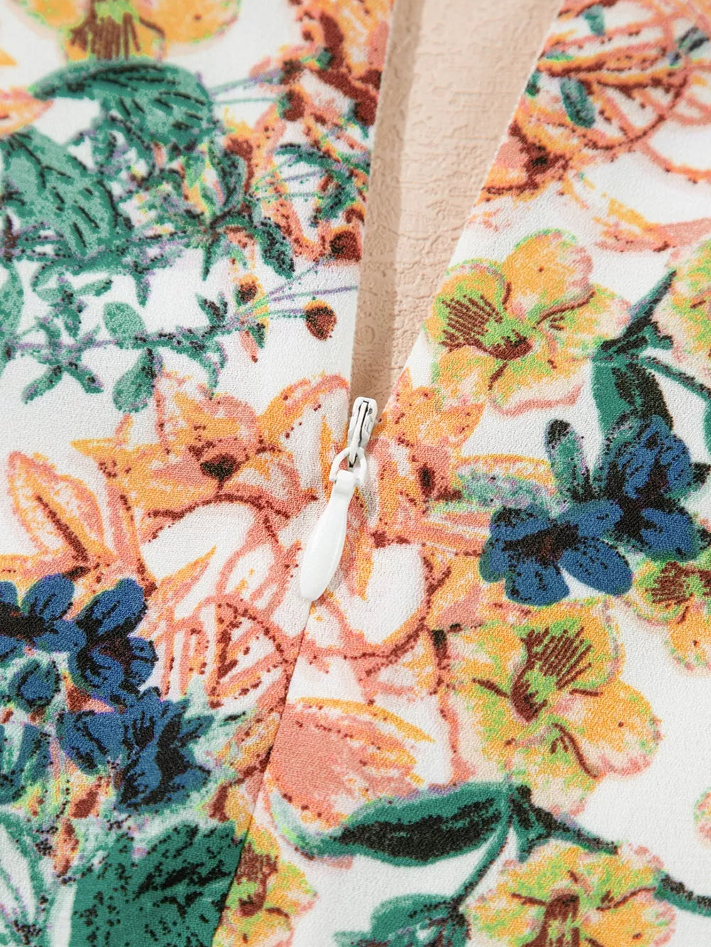 Close-up of floral print fabric showcasing the zipper of the Floral Print Ruffle Hem Mini Dress.