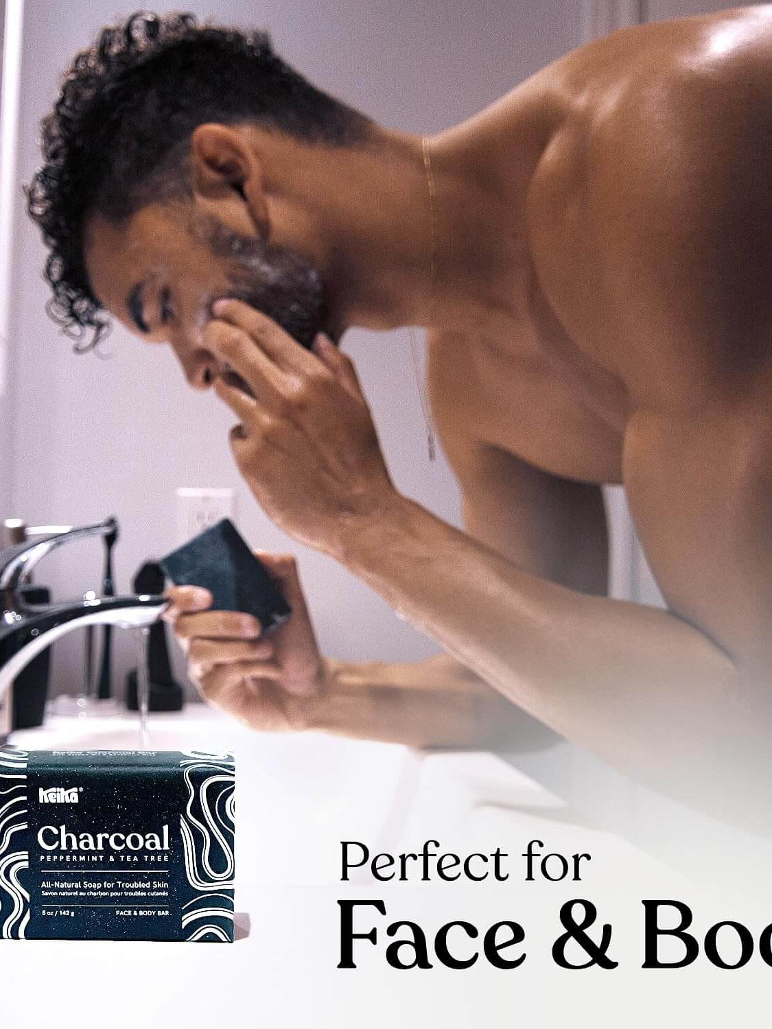 Keika Charcoal Black Soap Bar for face and body, suitable for men and teens with oily skin in modern bathroom setting.