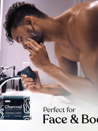 Keika Charcoal Black Soap Bar for face and body, suitable for men and teens with oily skin in modern bathroom setting.