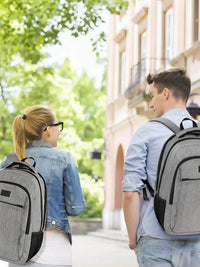 Couple walking in a city with MATEIN grey travel backpacks, ideal for business and college use.